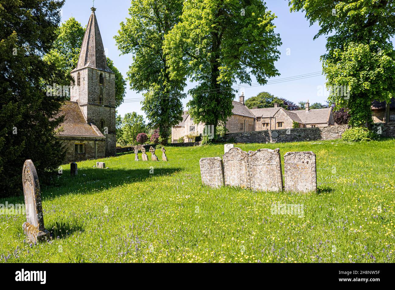 The 12th century church of St Bartholemew and the Manor House in the Cotswold village of Notgrove, Gloucestershire UK Stock Photo