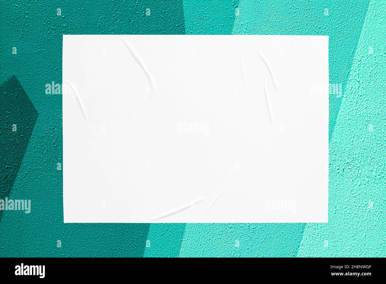 teal mint urban wall with glued poster Stock Photo