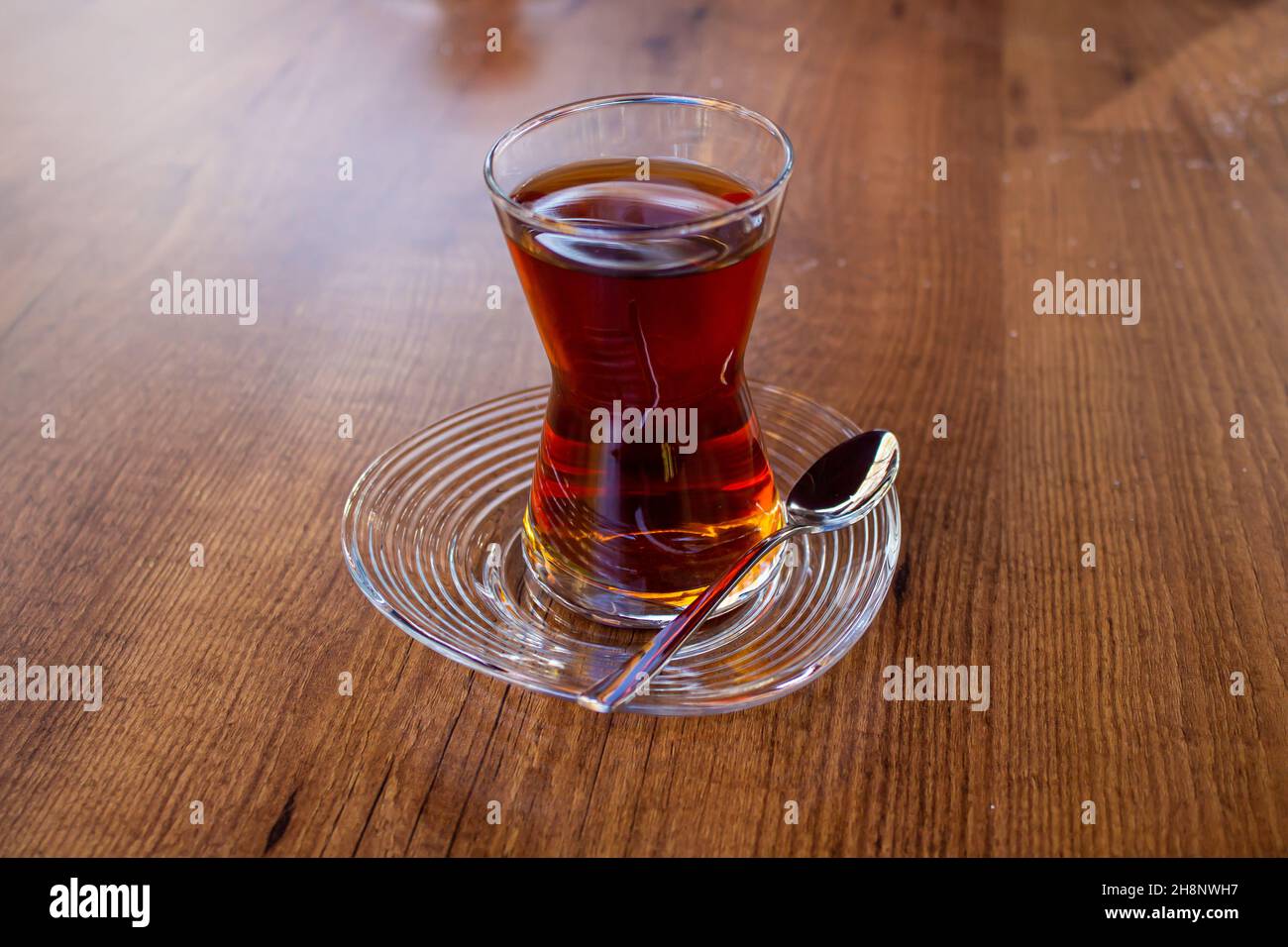 Turkish tea in glass, traditional Turkish tea on wooden table in a cafe. Stock Photo