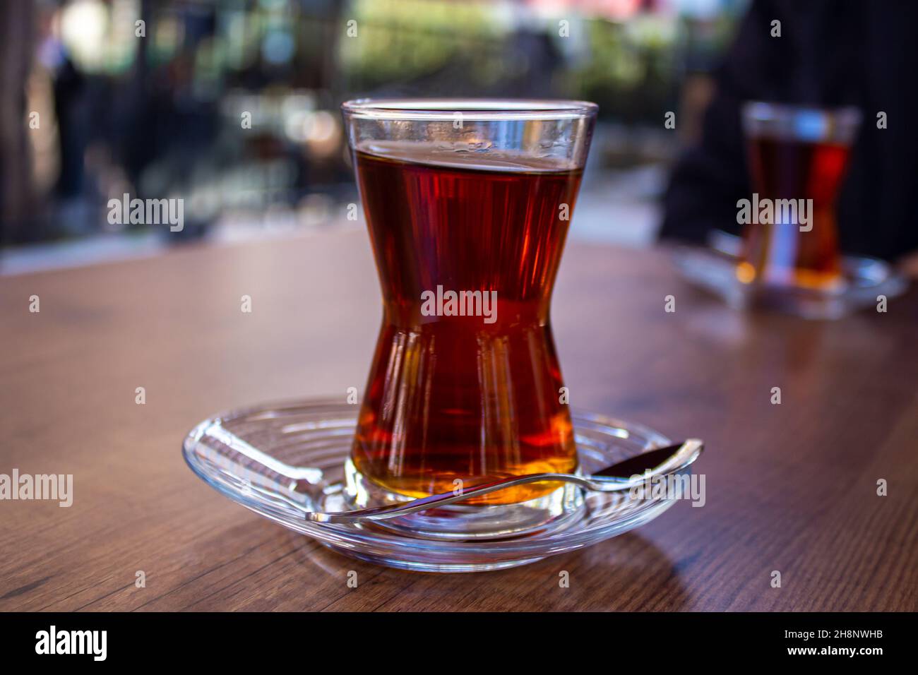 Turkish tea in glass, traditional Turkish tea on wooden table in a cafe. Stock Photo
