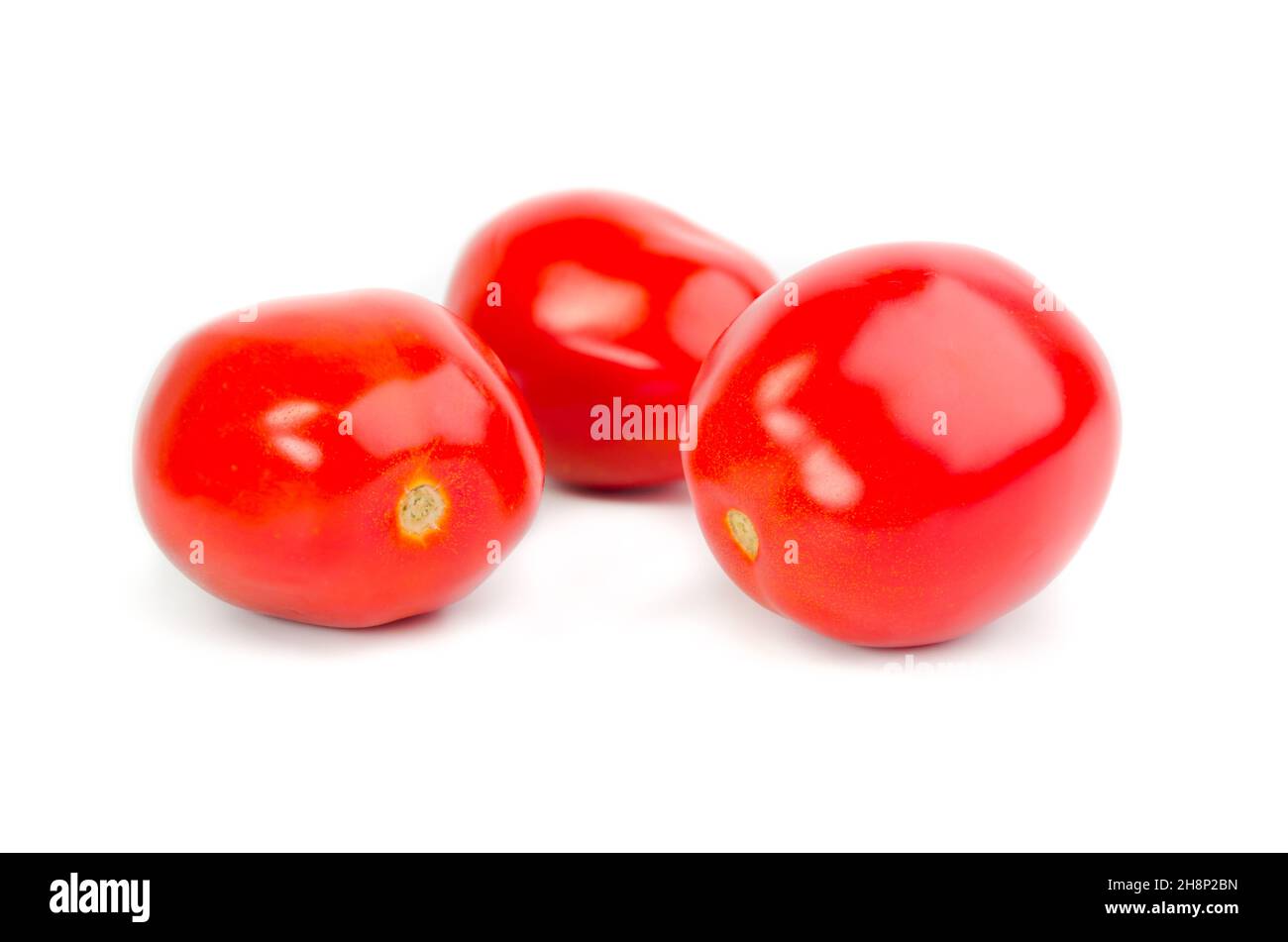 Three tomatoe isolated on white background Stock Photo - Alamy