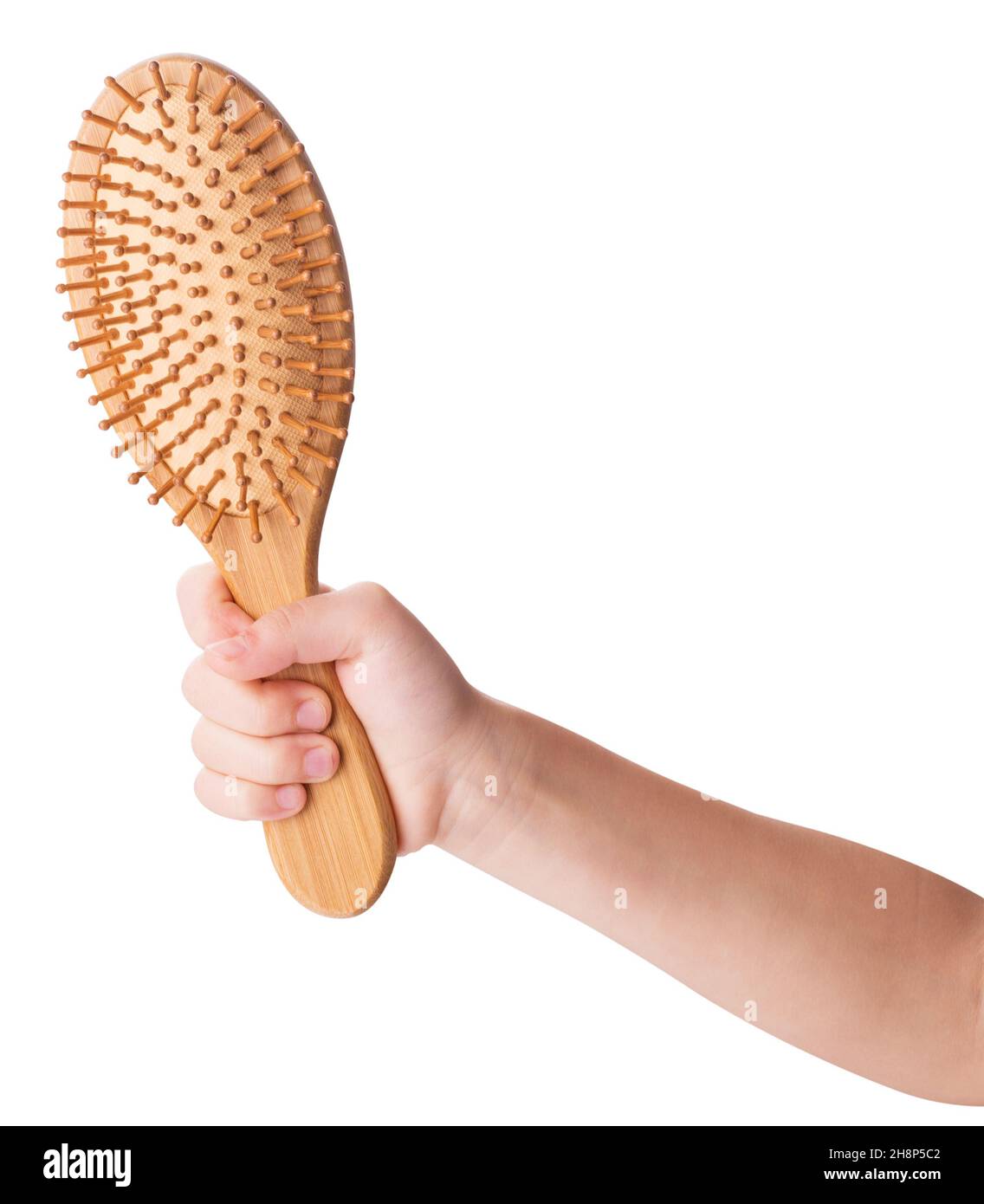 Wooden massage hairbrush in hand isolated on white background. Clipping