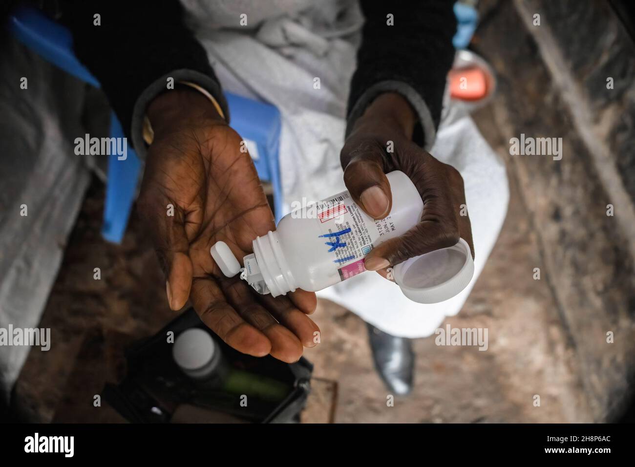 Nairobi, Kenya. 01st Dec, 2021. A woman takes her Antiretroviral drugs (ARVs) pills during the World Aids Day in Kibera.As today marks 33 years since the beginning of World Aids Day and 40 years since the first case of HIV, it's also one of the greatest days to help put an end to inequality that drives Aids and other pandemics across the world. Credit: SOPA Images Limited/Alamy Live News Stock Photo