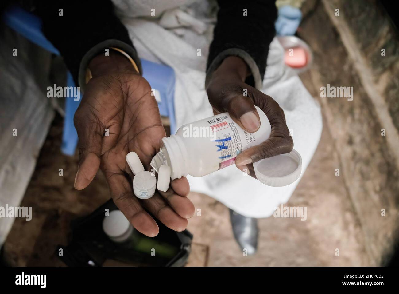 Nairobi, Kenya. 01st Dec, 2021. A woman takes her Antiretroviral drugs (ARVs) pills during the World Aids Day in Kibera.As today marks 33 years since the beginning of World Aids Day and 40 years since the first case of HIV, it's also one of the greatest days to help put an end to inequality that drives Aids and other pandemics across the world. Credit: SOPA Images Limited/Alamy Live News Stock Photo
