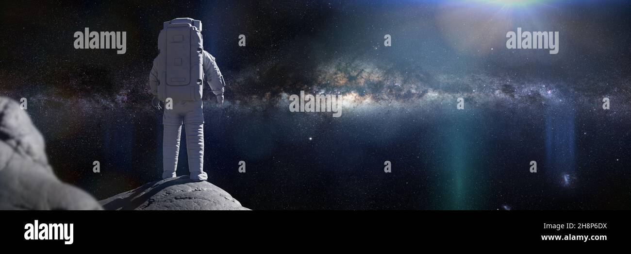 astronaut on the Moon, spaceman watching the Milky Way galaxy Stock Photo