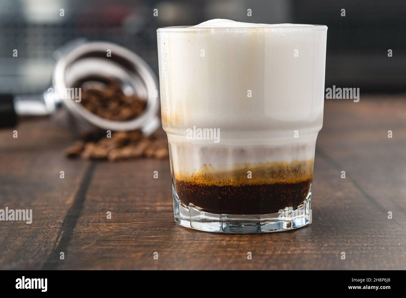 Cortado coffee with coffee beans next to it. Traditional coffee in