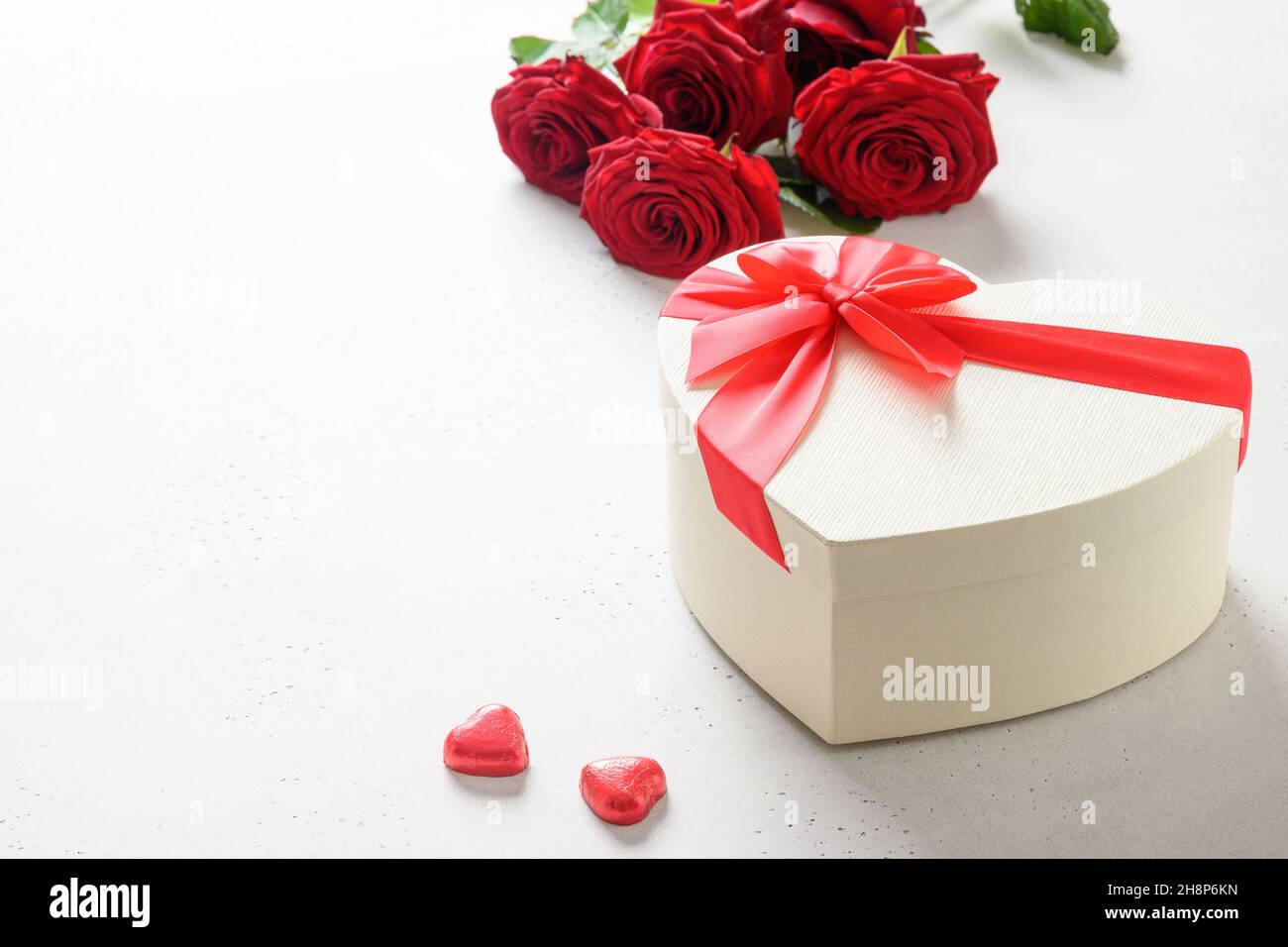 Valentine's day gift box as heart, red chocolate sweets and bouquet of ...