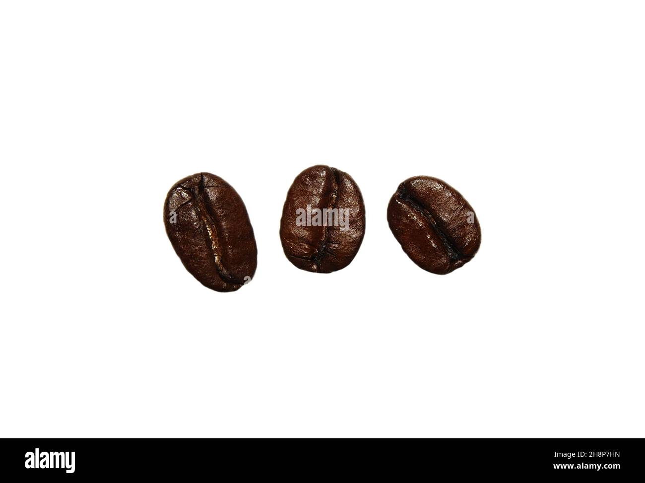 Fresh roasted coffee beans isolated on a white background. Close up of ...