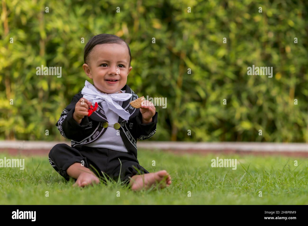 Little latin baby boy with a mariachi costume happy smilling enjoying Stock Photo