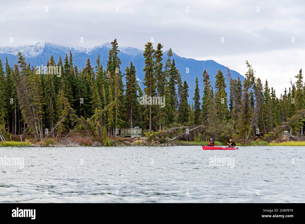 Pine Lake near Haines Junction in the Yukon, Canada. Anglers fish from a boat on the lake. Stock Photo