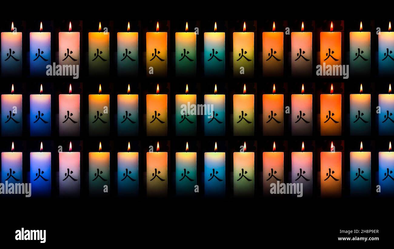 Many colorful burning candles on a black background Stock Photo - Alamy