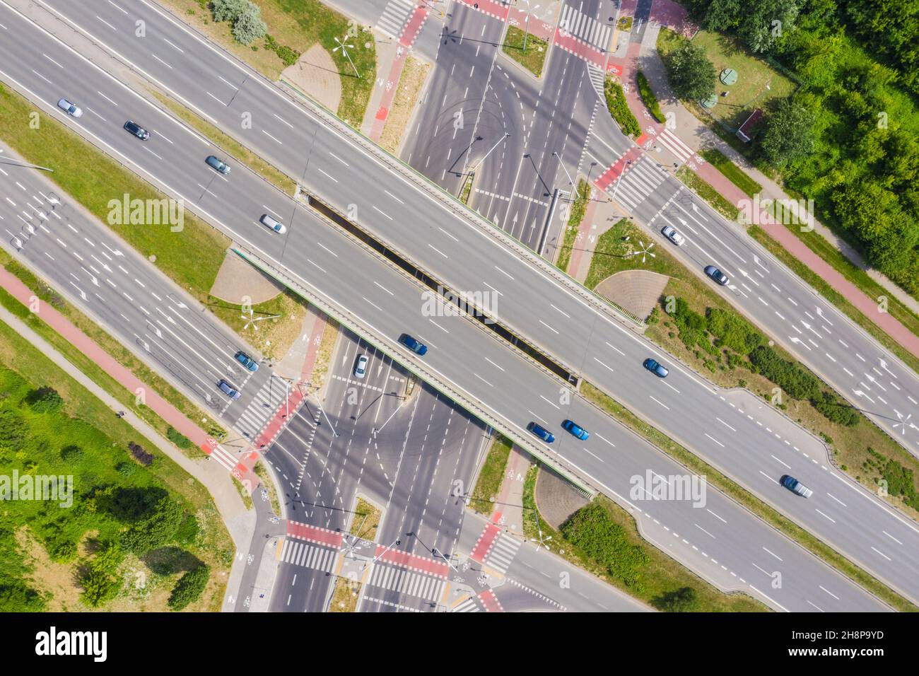 Traffic trails on highway intersection. Aerial View. Green Forest Stock Photo