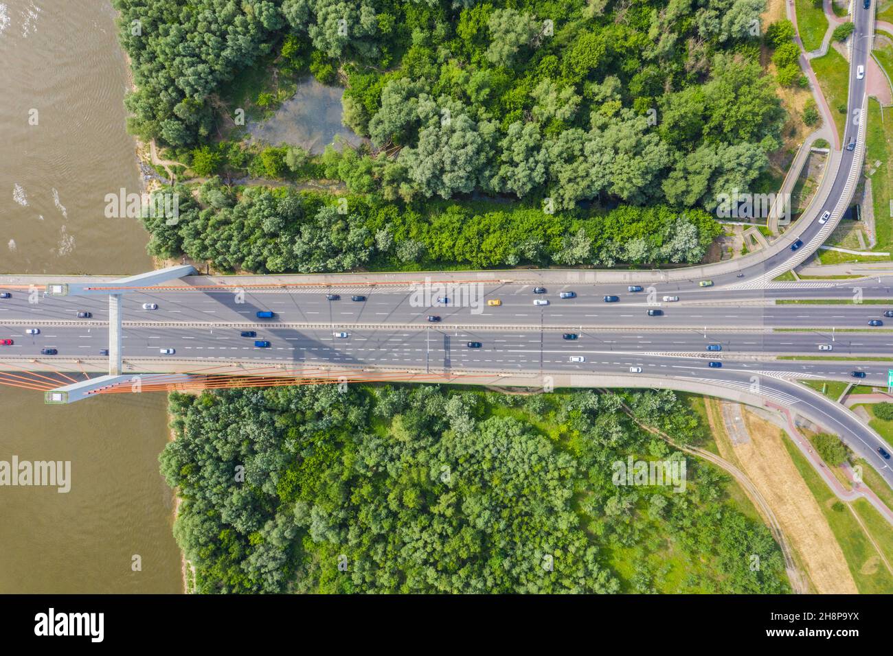 Car driving on highway bridge and road intersection in modern city aerial view Stock Photo