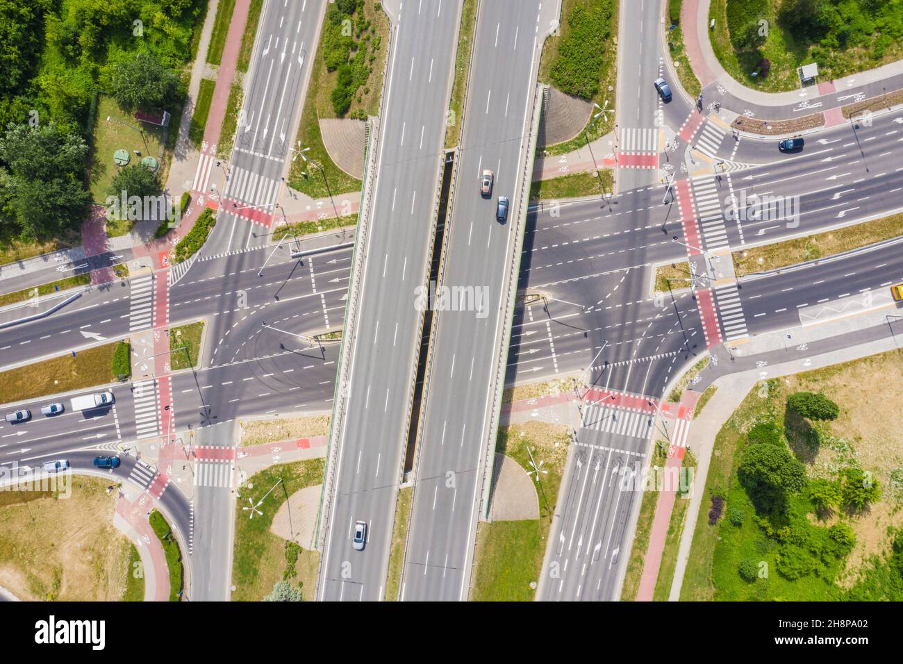 Traffic trails on highway intersection. Aerial View. Green Forest Stock Photo