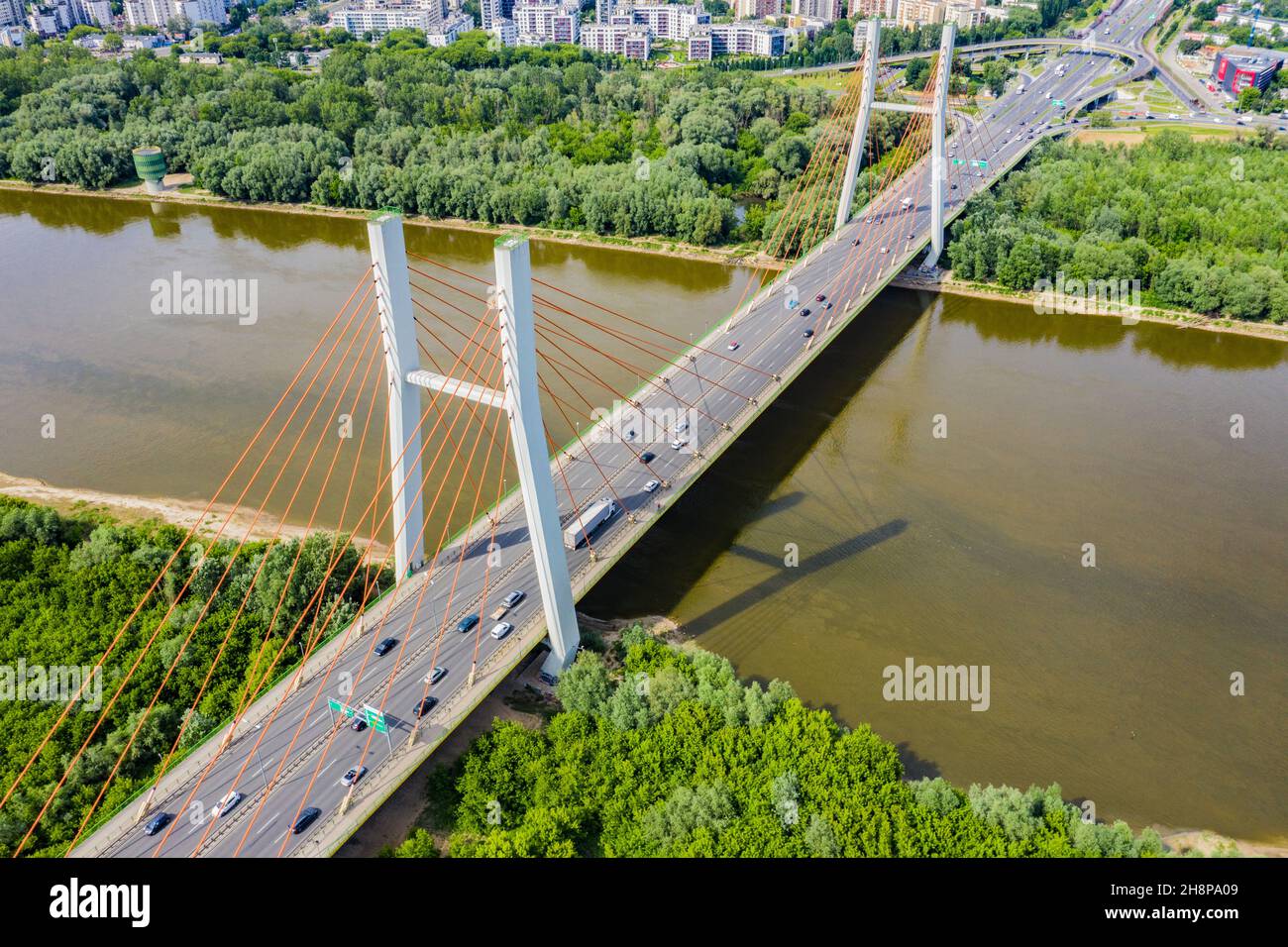Aerial shooting from flying drone car traffic on modern highway bridge over river Stock Photo