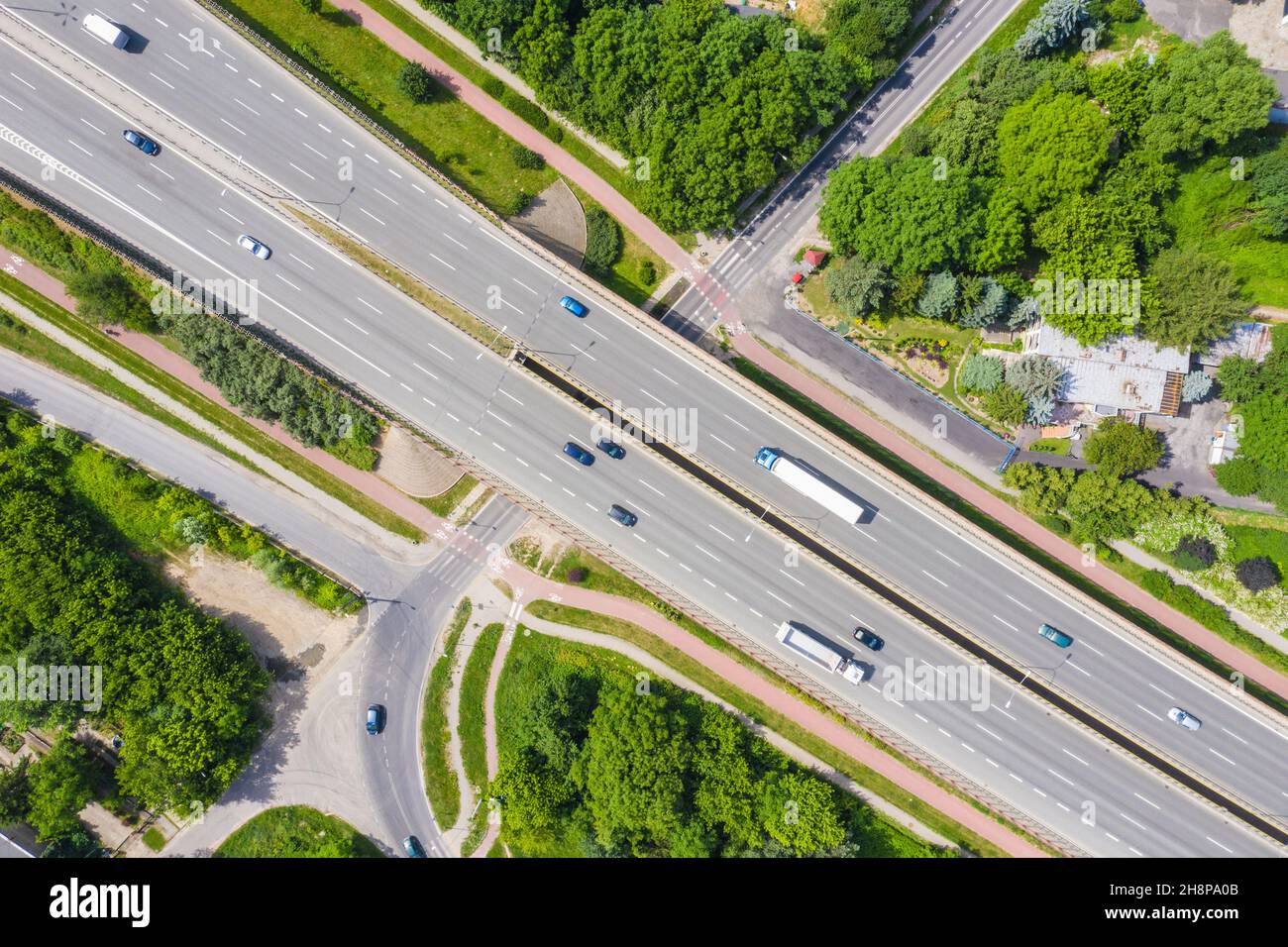 Traffic trails on highway intersection. Aerial View. Green Forest Stock Photo