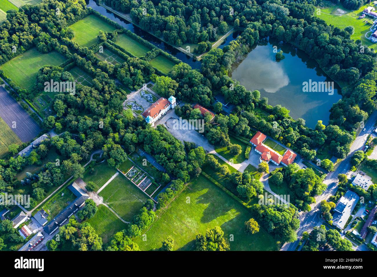 Beautiful avenue of trees of Nieborow Palace, a Baroque style residence in Poland. Colourful foliage in a French-design garden. Aerial view Stock Photo