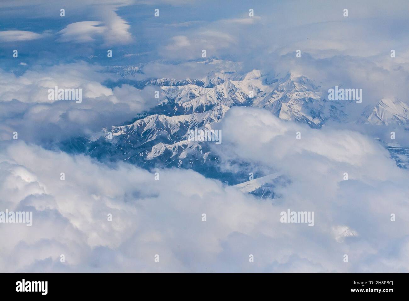 Aerial view of the majestic Denali mountain range with white cloud coverage. Stock Photo