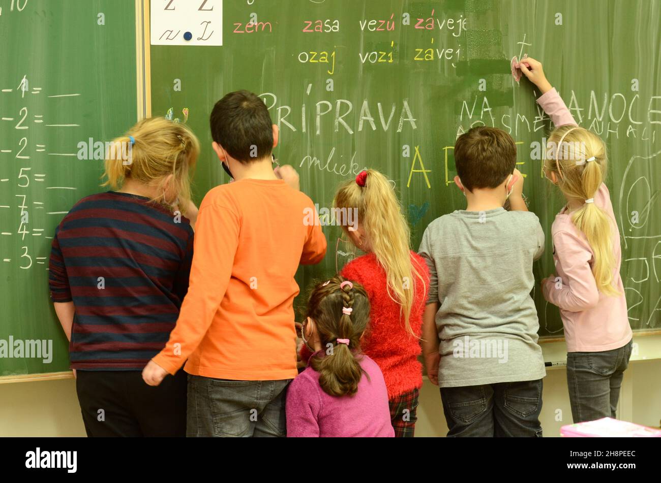 children at school, pupils in the classroom, the hand that writes, relaxed pupils, relaxed atmosphere in the classroom, modern teaching, teamwork Stock Photo