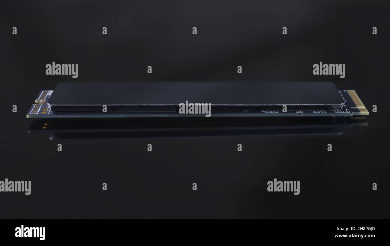 SSD M2 disk close up side view isolated with clipping path. On dark ...