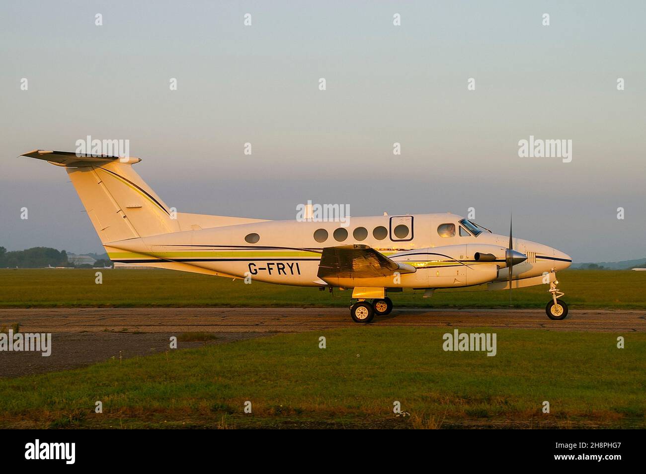 London Executive Aviation Beechcraft Super King Air 200 plane G-FRYI taxiing for flight on a misty dawn morning at London Southend Airport, UK Stock Photo