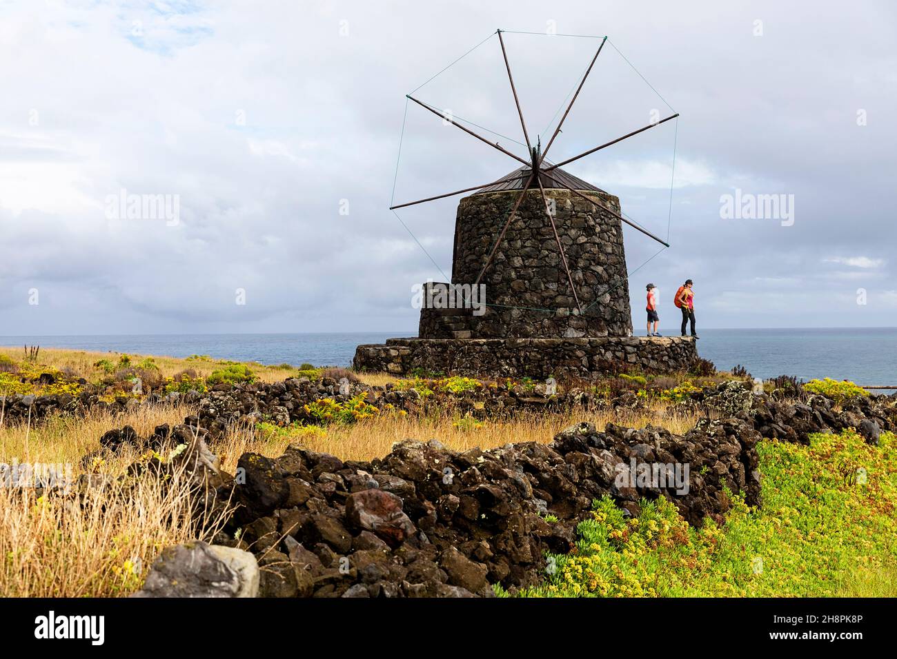 Mother and son walking to traditional windmills, Vila do Corvo, Corvo, Azores, Portugal Stock Photo