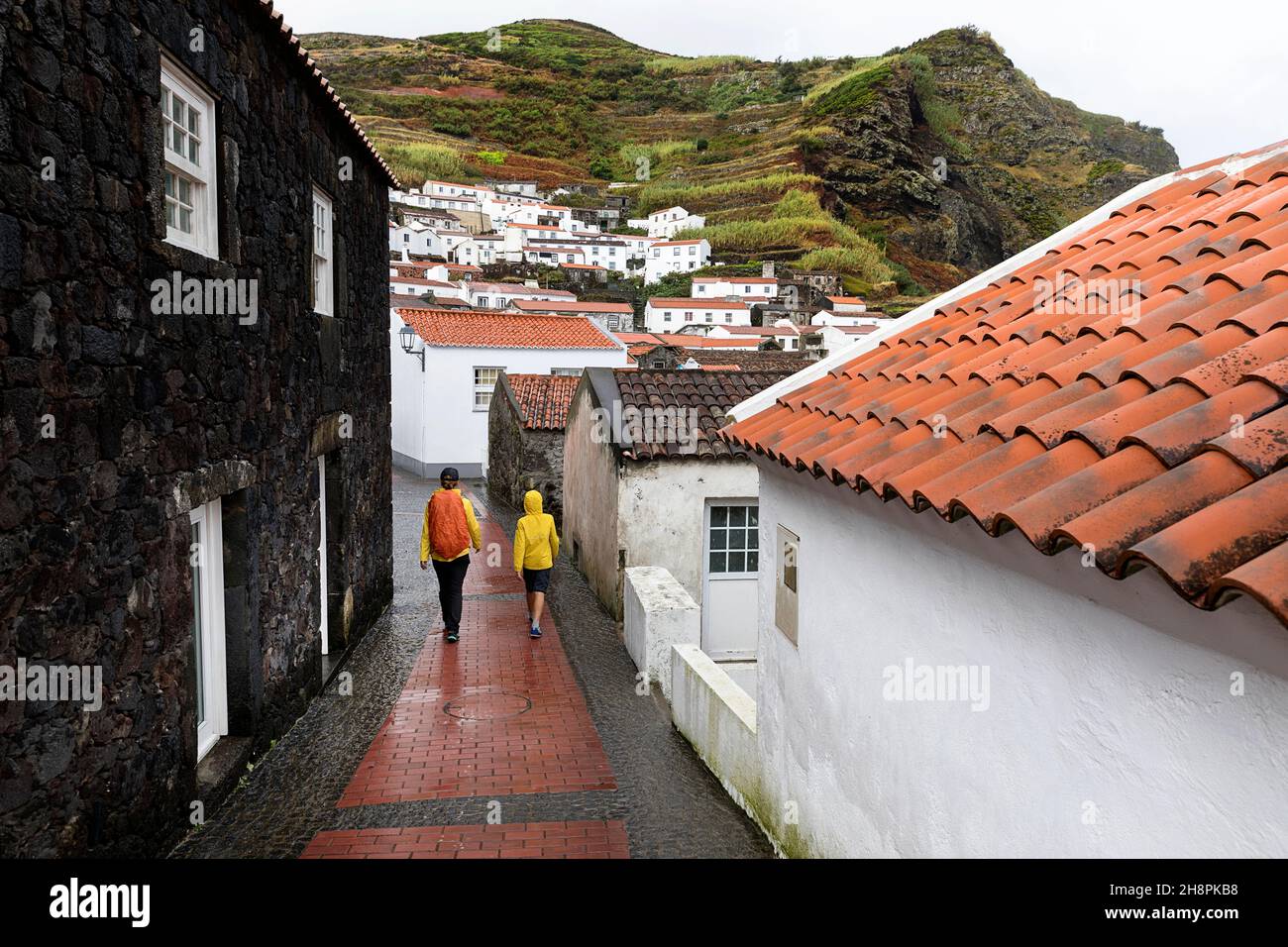 Mother and son tourists walking on narrow streets of Vila do Corvo, Corvo Island Azores Portugal Stock Photo