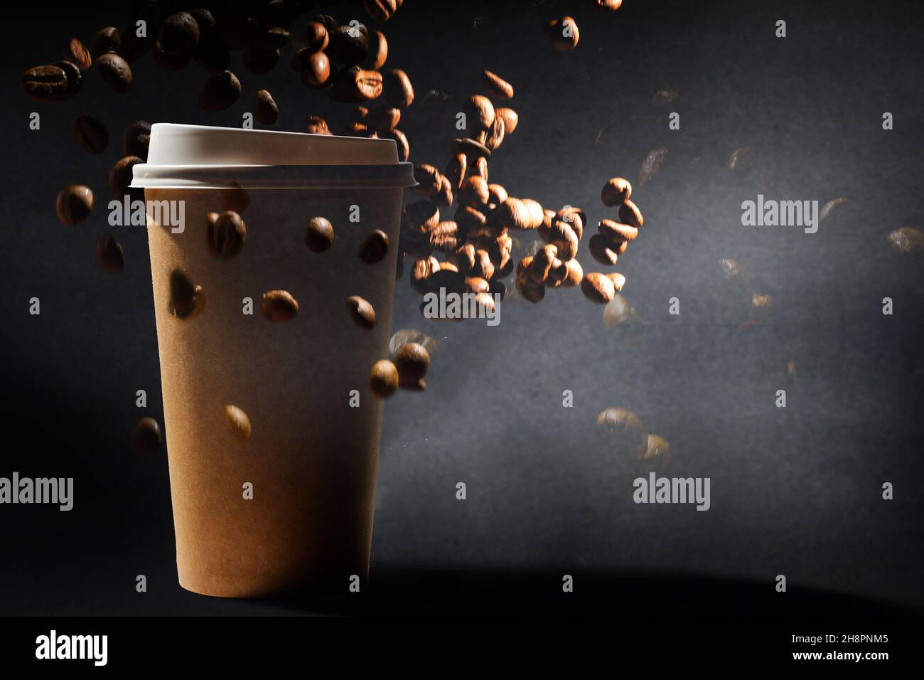 Photo of a paper coffee cup with a mixture of arabica and robusta beans ...