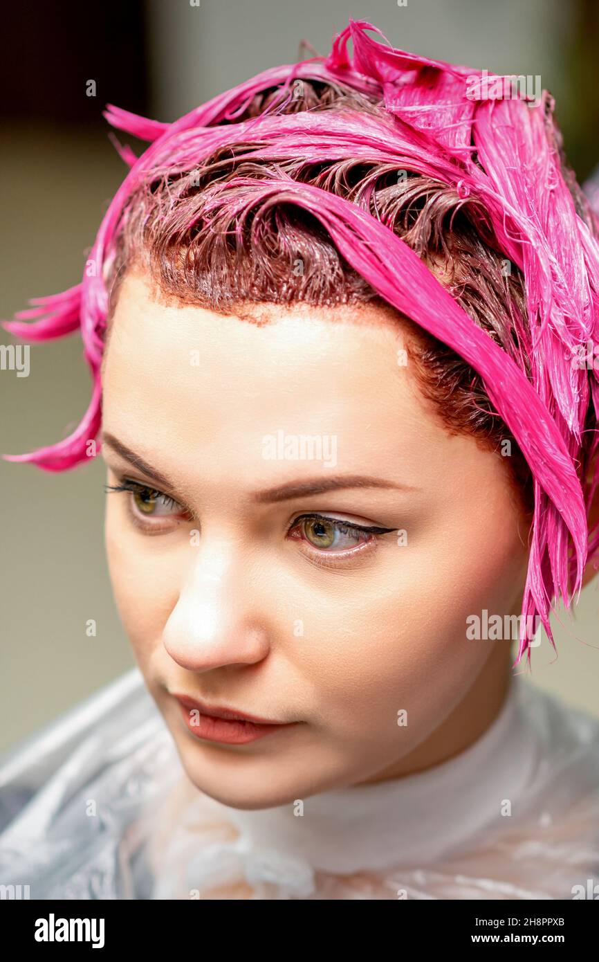 Premium Photo  The professional hairdresser uses a brush to apply the pink  dye to the hair. hair coloring concept.