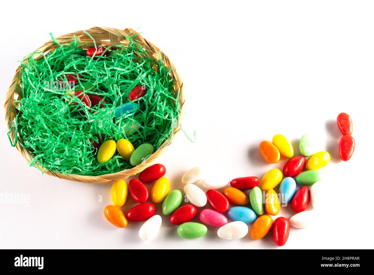 Easter basket with colorful Easter eggs on a light background Stock Photo