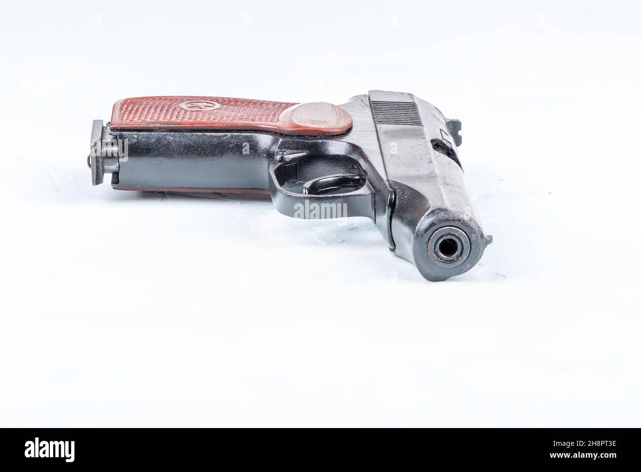 Used Makarov pistol on a light blue background with space for text. Close up. Stock Photo