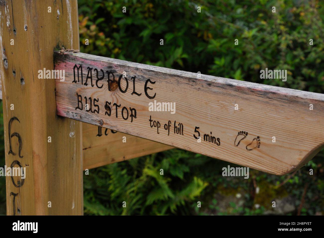 The wooden sign post in Holy Vale indicates the time and direction to ...