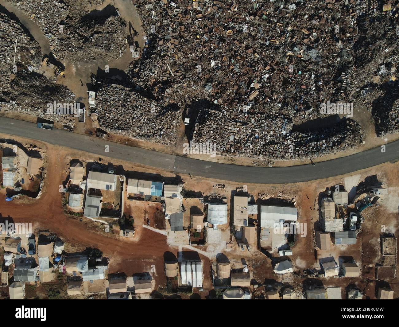 (EDITOR'S NOTE : Image taken with drone) A scrapyard is seen near the tents of a IDP (internal displaced people) camp in north of Idlib. Stock Photo