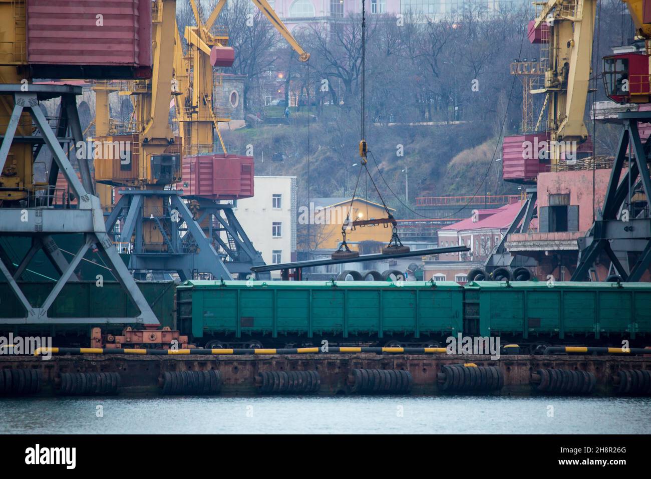 Railroad cars in port for loading unloading. Port cranes unload, load ...