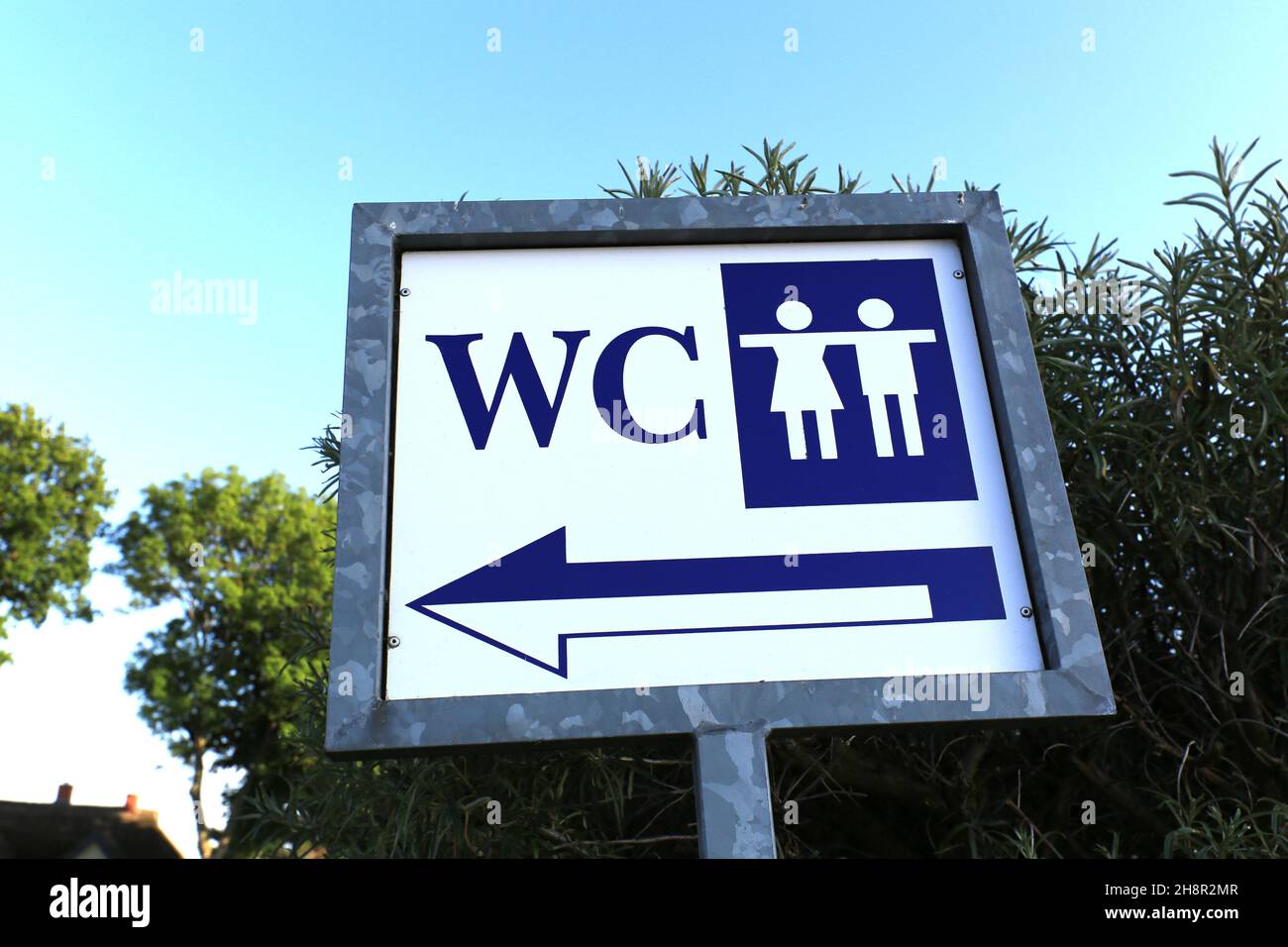 Directional sign for a public restroom for men and women Stock Photo