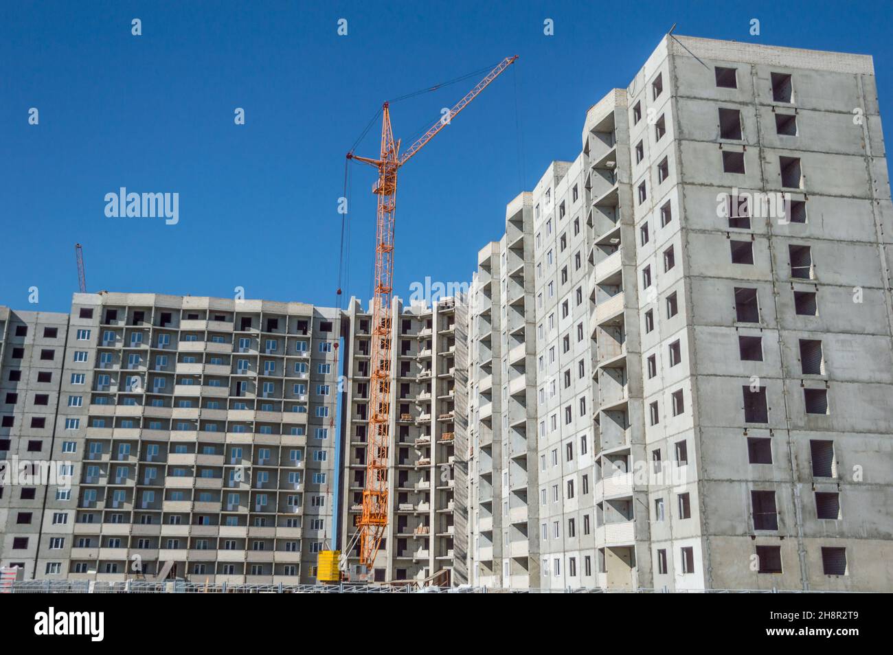 Construction work site and hoisting tower cranes Stock Photo