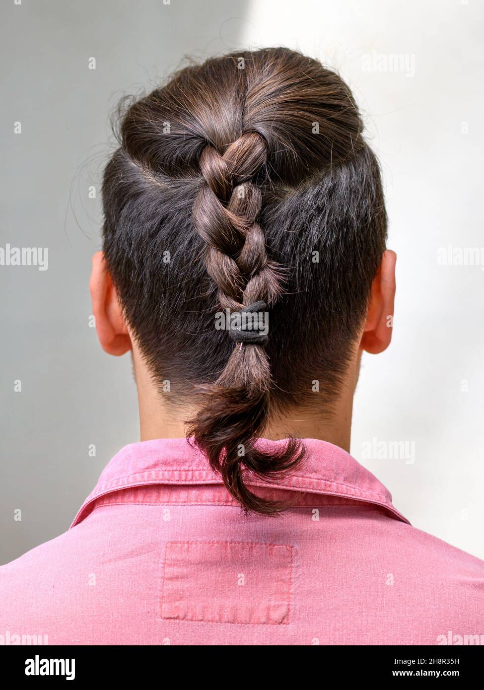 men's hairstyle with braided hair. Close-up photo from behind Stock ...