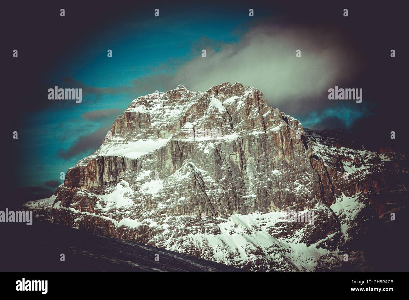 Vintage effect of western face of Mount Sorapiss at sunset in winter Stock Photo