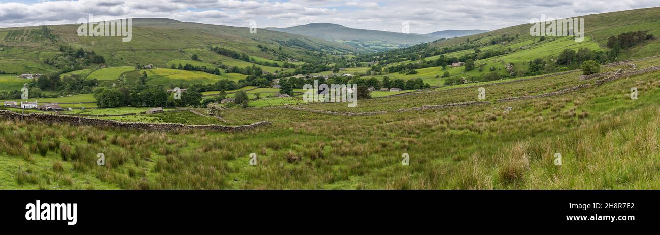 Panorama view of Dentdale looking into Cumbria with rough pasture and dry stone walls in foreground; farm buildings and distant hills in background Stock Photo