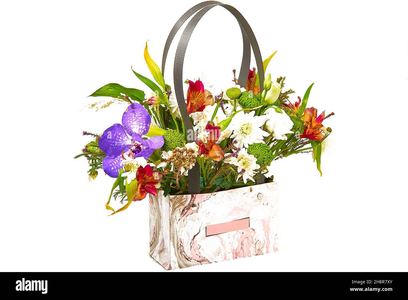 Flower arrangement in a cardboard bag with plastic handles for flower