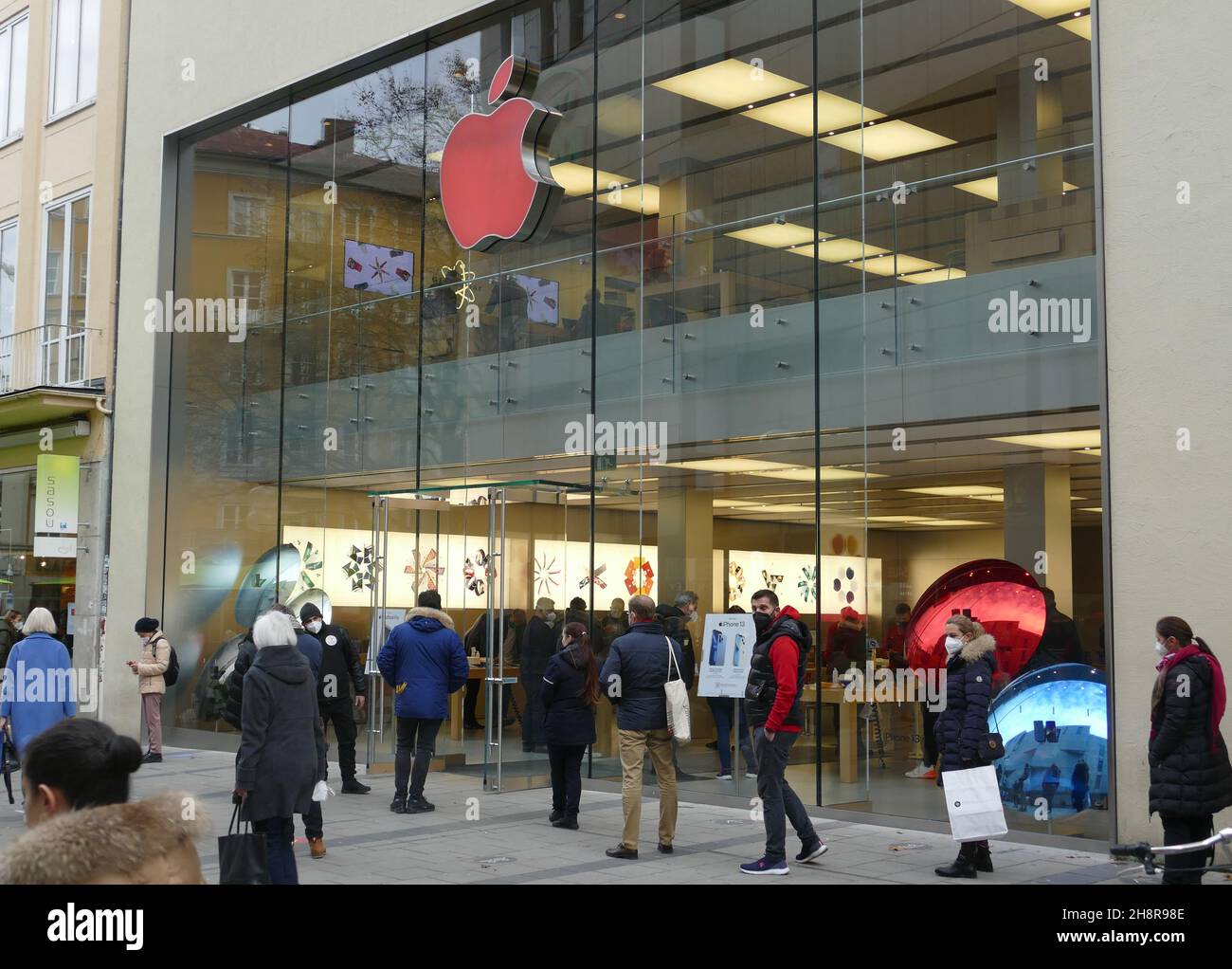 Apple store logo in red because of World Aids Day in December 2021. Stock Photo