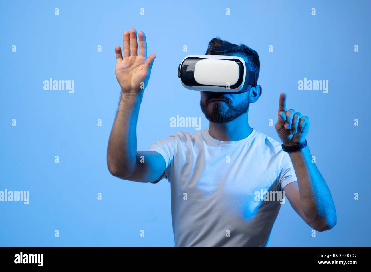 Young man developer working with a VR headset in a virtual world and