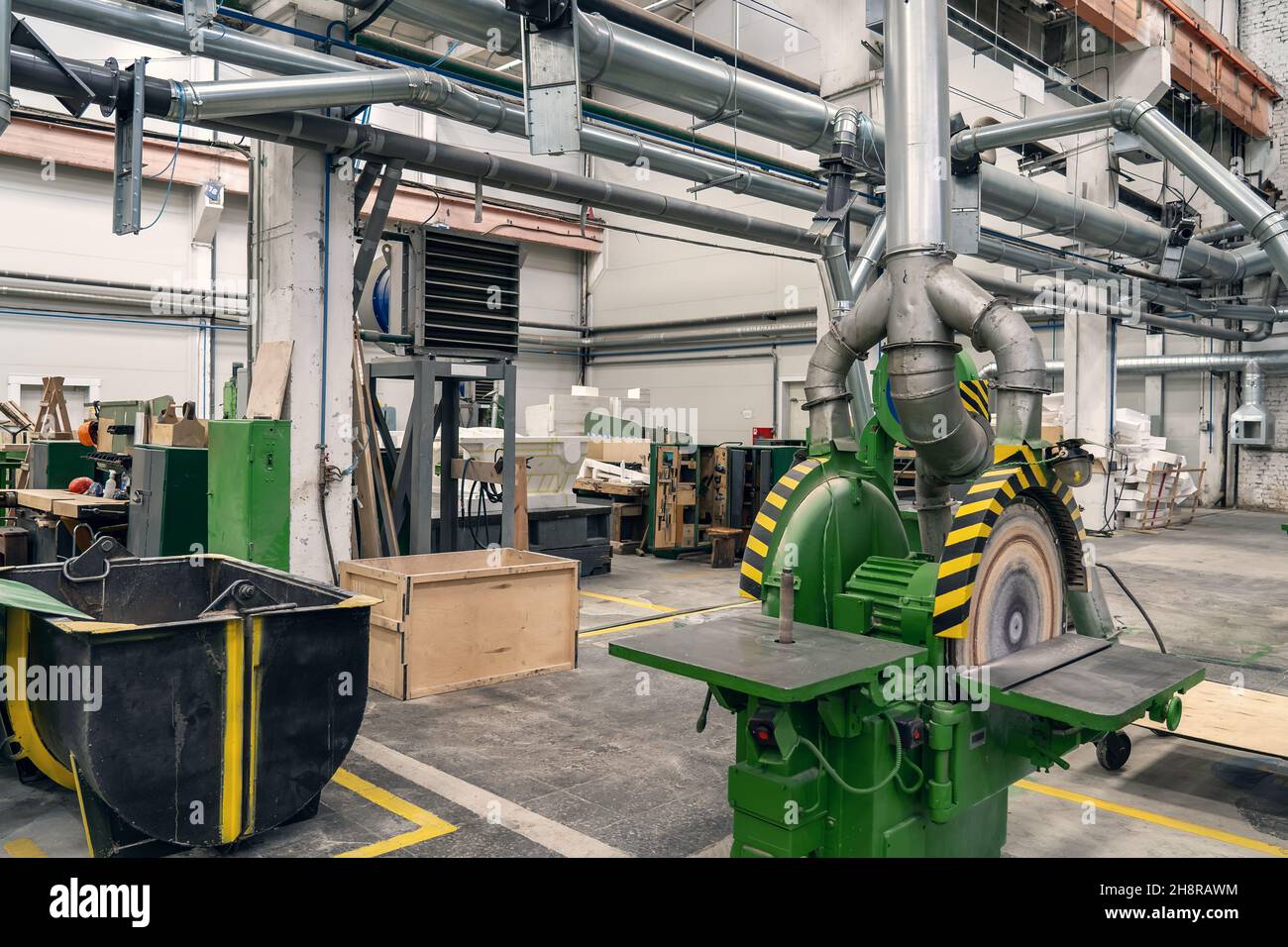 Woodwork factory with machines, lathes and steel pipes for processing. Stock Photo