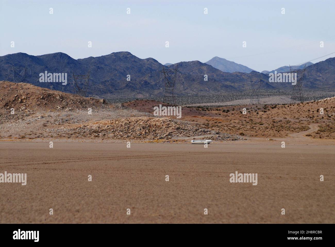 This Nevada desert landscape shows the effects of climate change, featuring a dried up lake complete with a stranded boat. Stock Photo