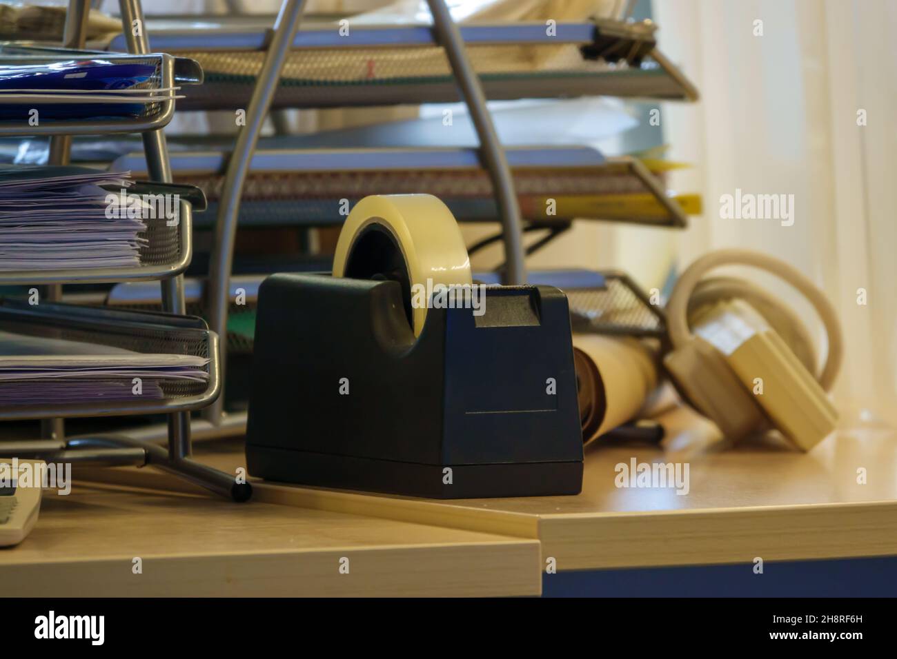 sticky tape dispenser with a full reel of sticky tape mounted, on a