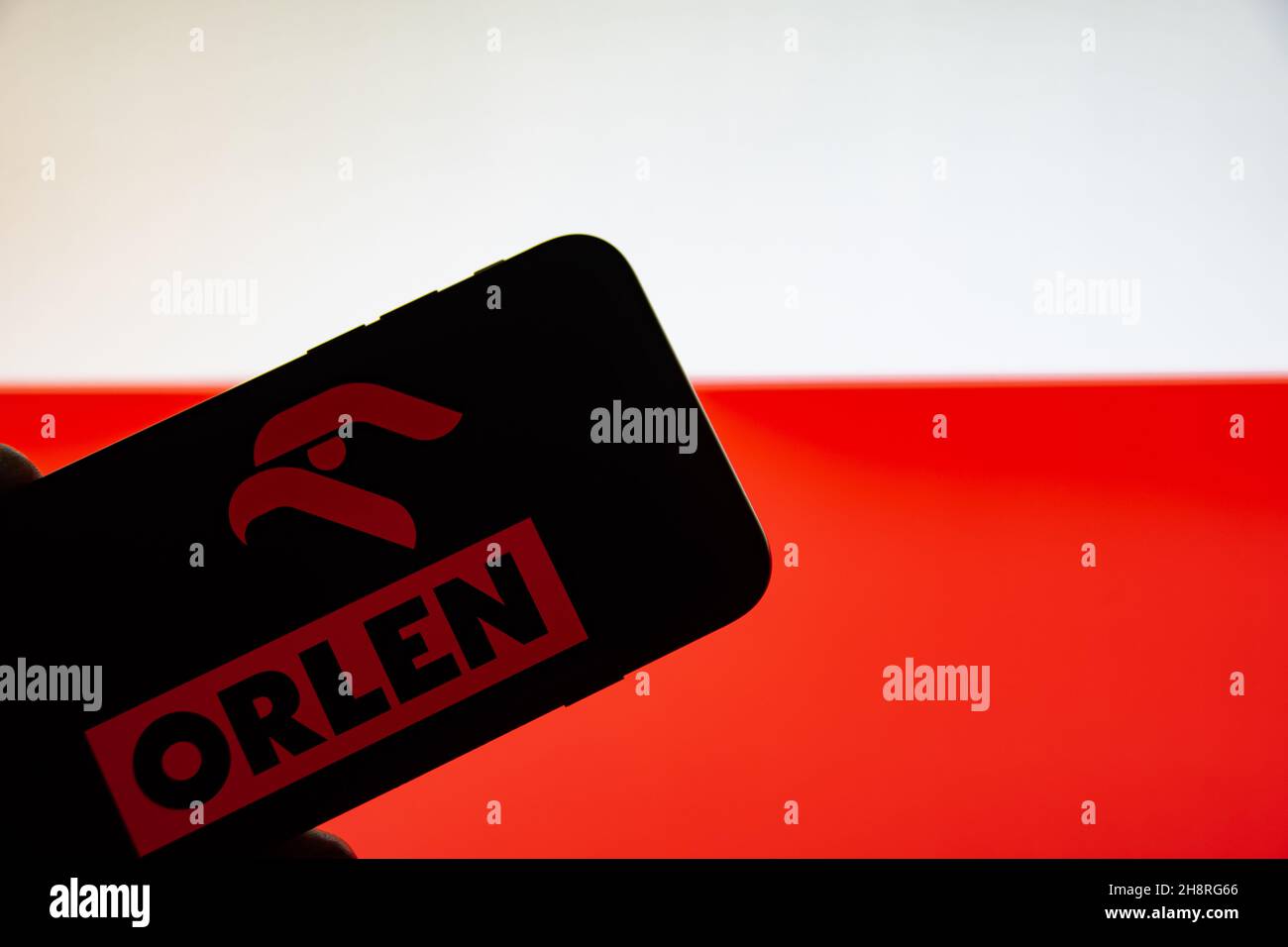 Rheinbach, Germany  2 December 2021,  The brand logo of the petrol station operator 'Orlen' on the display of a smartphone (focus on the brand logo) Stock Photo