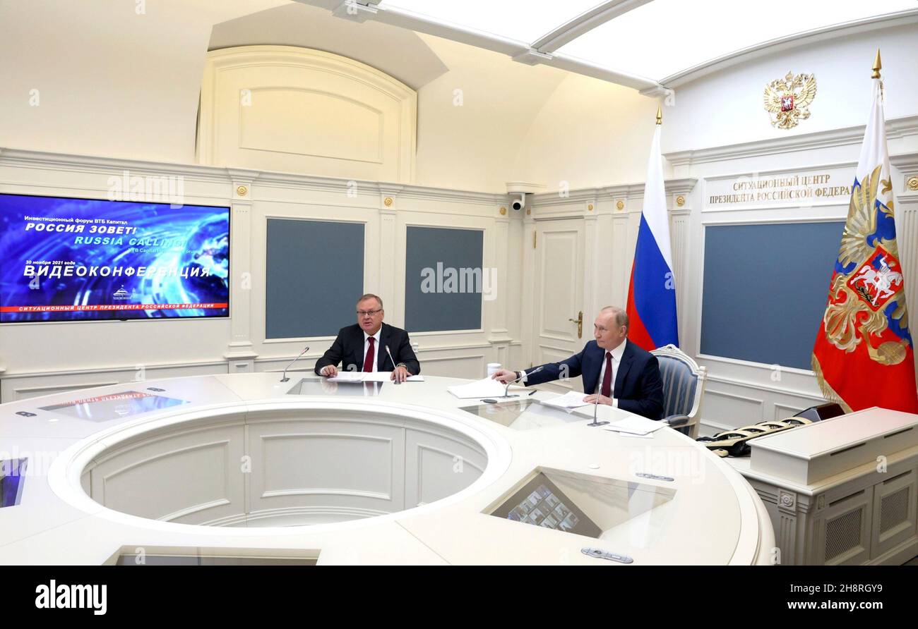 Moscow, Russia. 30 November, 2021. Russian President Vladimir Putin, right, and VTB Bank Chairman Andrei Kostin attend a virtual event with the annual VTB Capital 'Russia Calling!” Investment Forum November 30, 2021 in Moscow, Russia.  Credit: Mikhail Metzel/Kremlin Pool/Alamy Live News Stock Photo