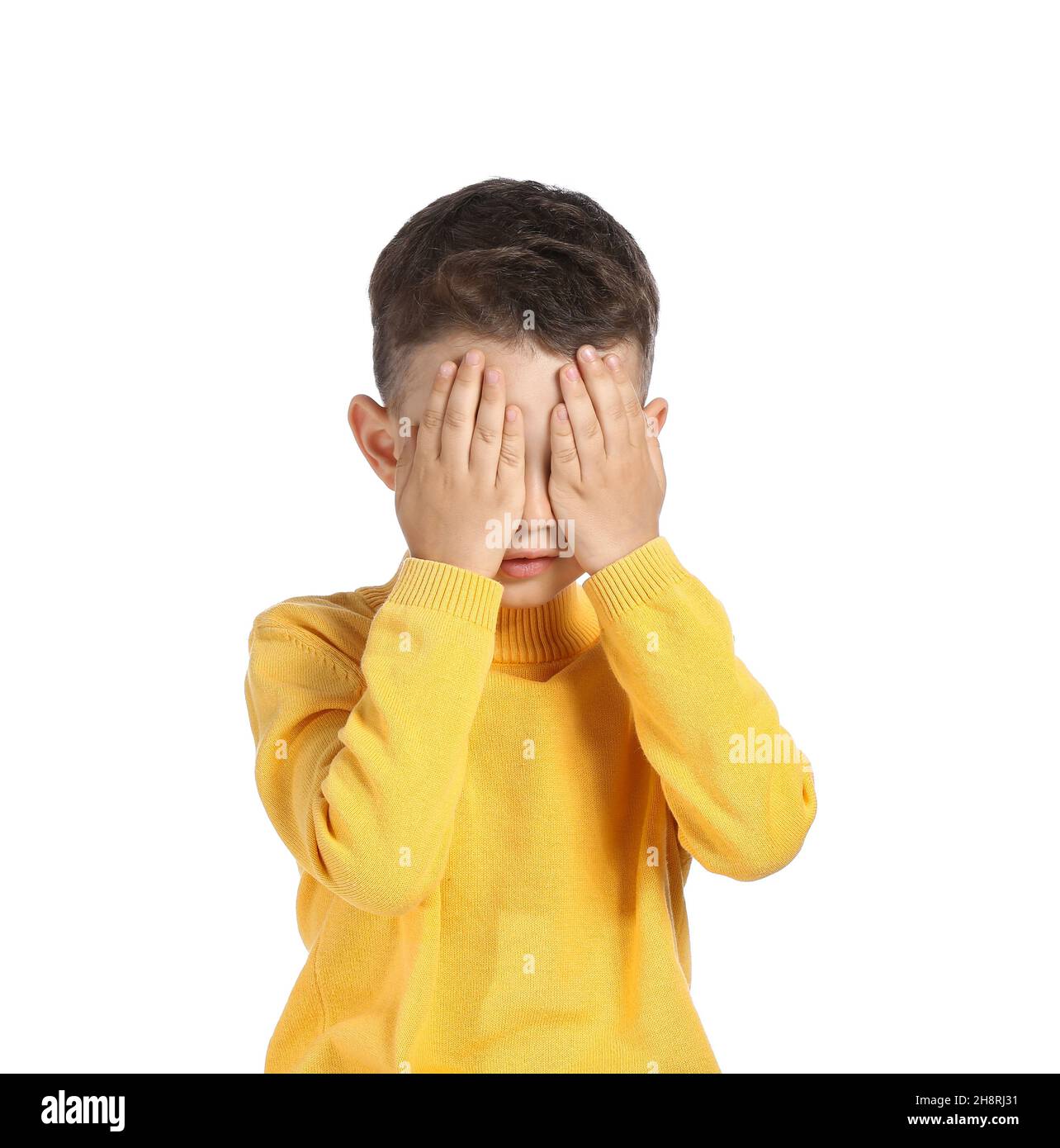 Portrait of cute little boy covering eyes with his hands on white ...