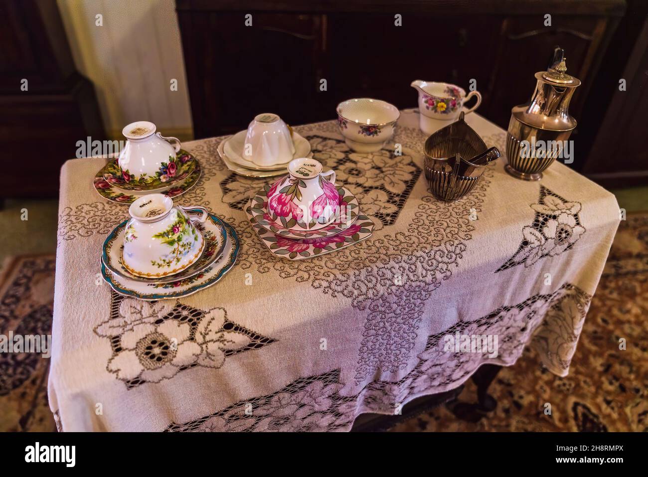 Table set with linen and crockery for afternoon tea in historical homestead grain enhancement