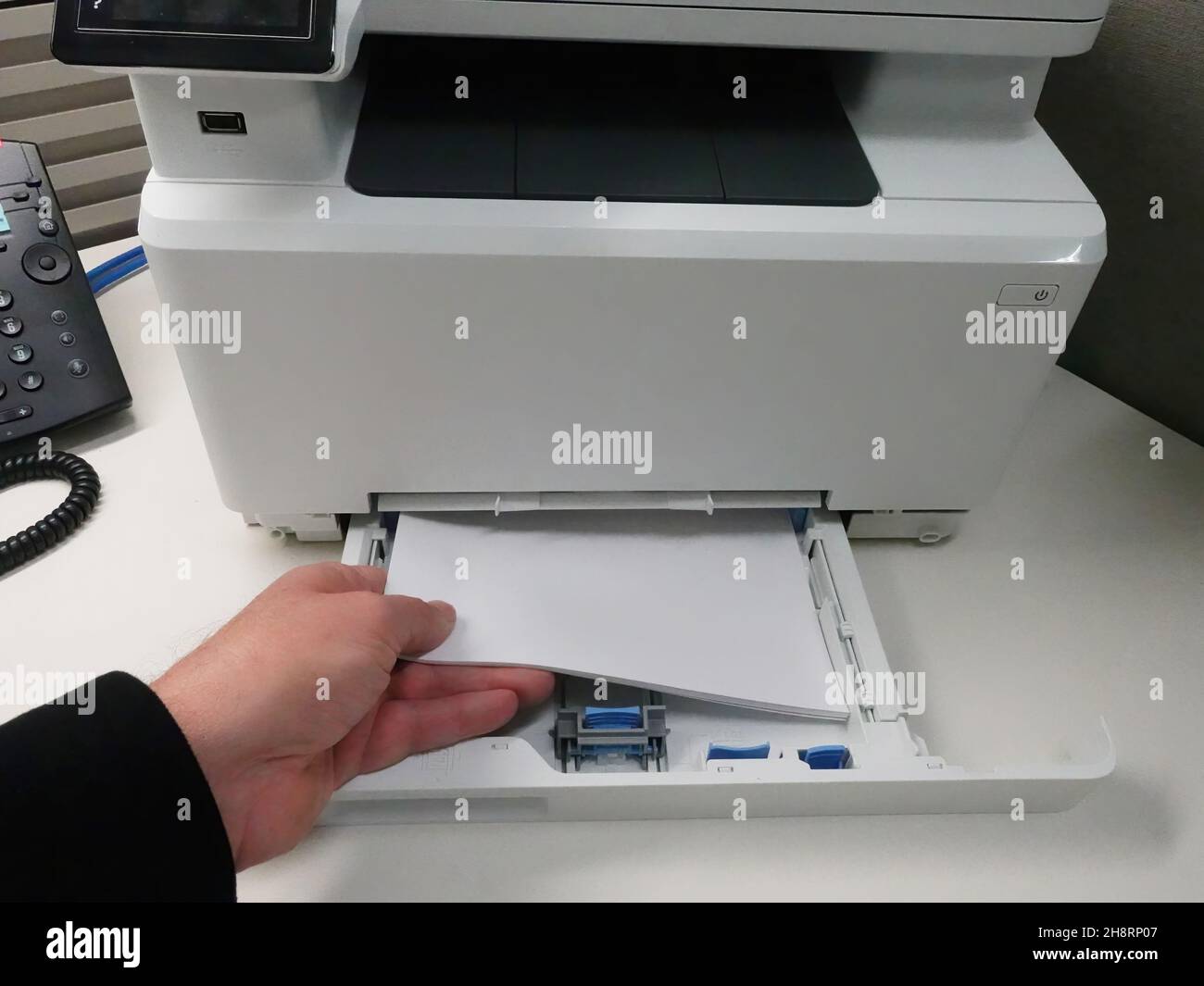 Man loading paper into printer paper tray Stock Photo Alamy